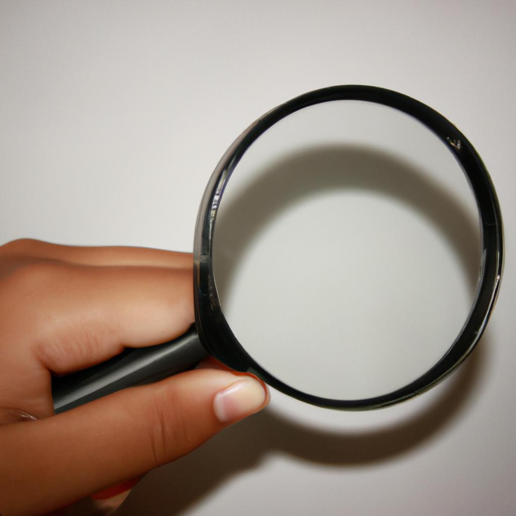 Person holding a magnifying glass